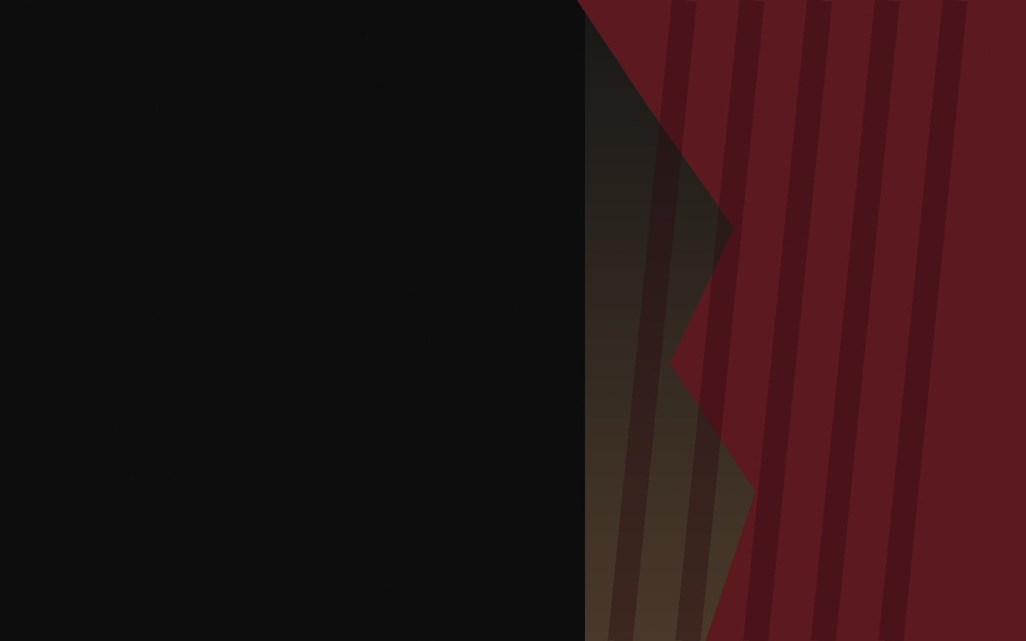The heavy edge of a wine-coloured stage curtain beside a dark opening