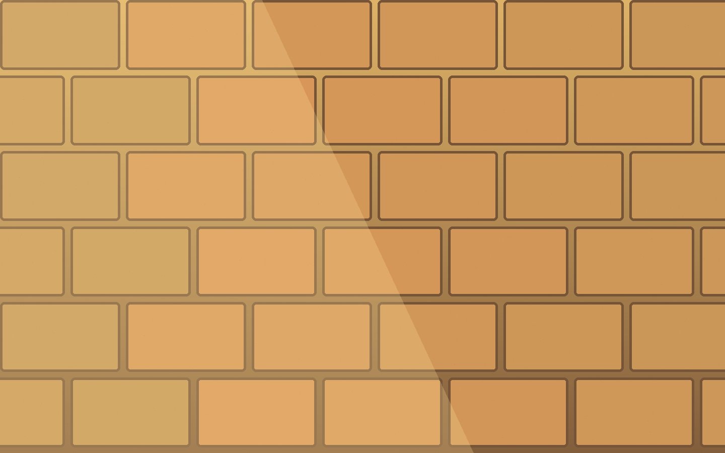 A rough stone wall divided by hard sunlight and shadow